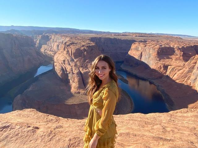 Jessica Penrose stands in front of the Grand Canyon